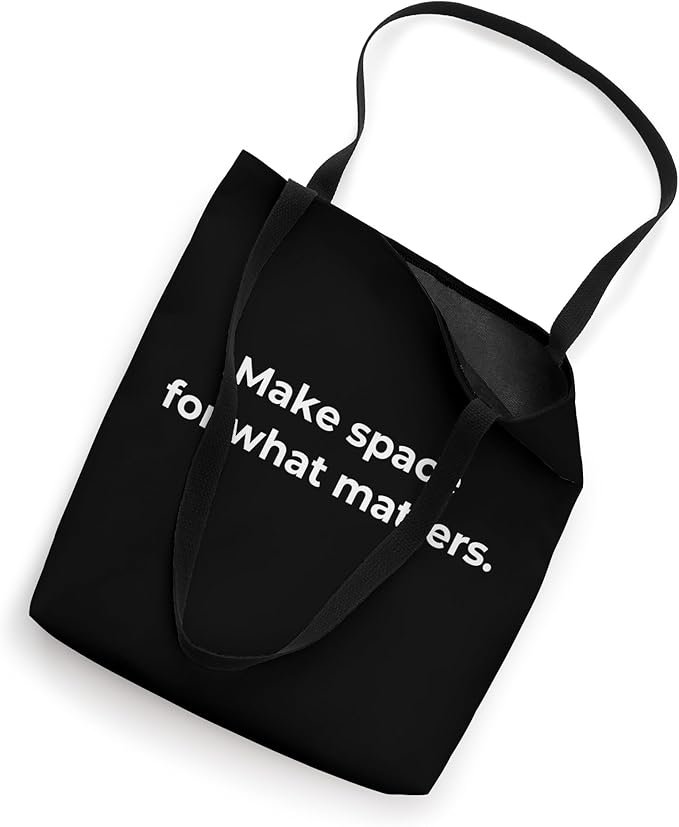 Black reusable tote bag with the minimalist quote "Make space for what matters," ideal for decluttering and simplifying life.