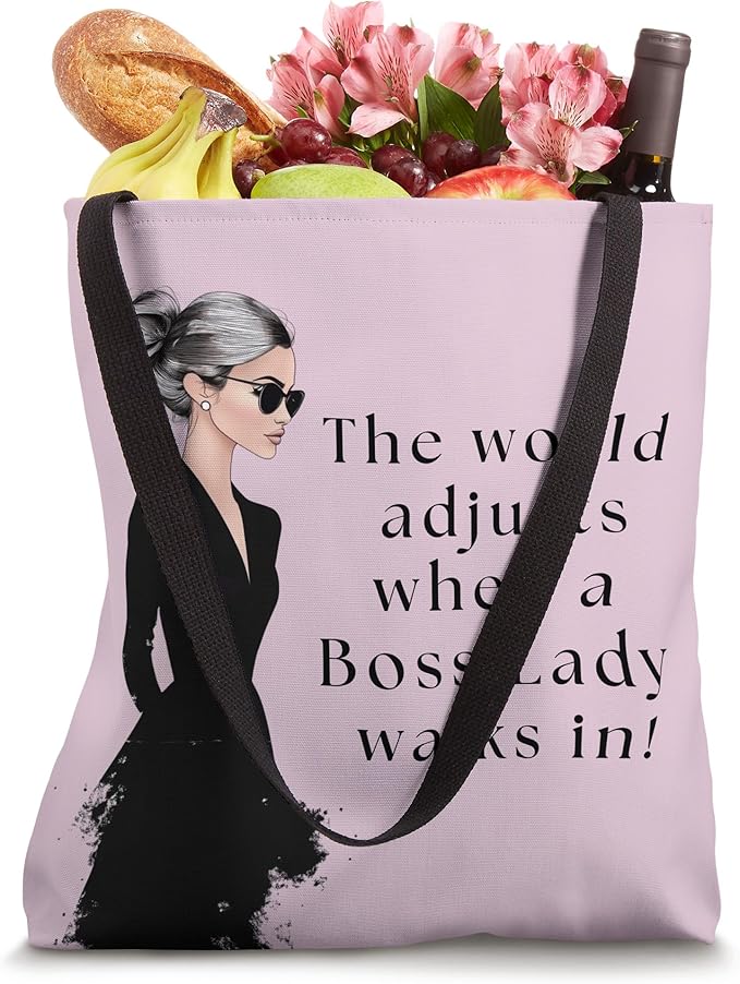 Stylish boss lady tote bag with an empowering quote, featuring a confident woman in black and a soft pink background.